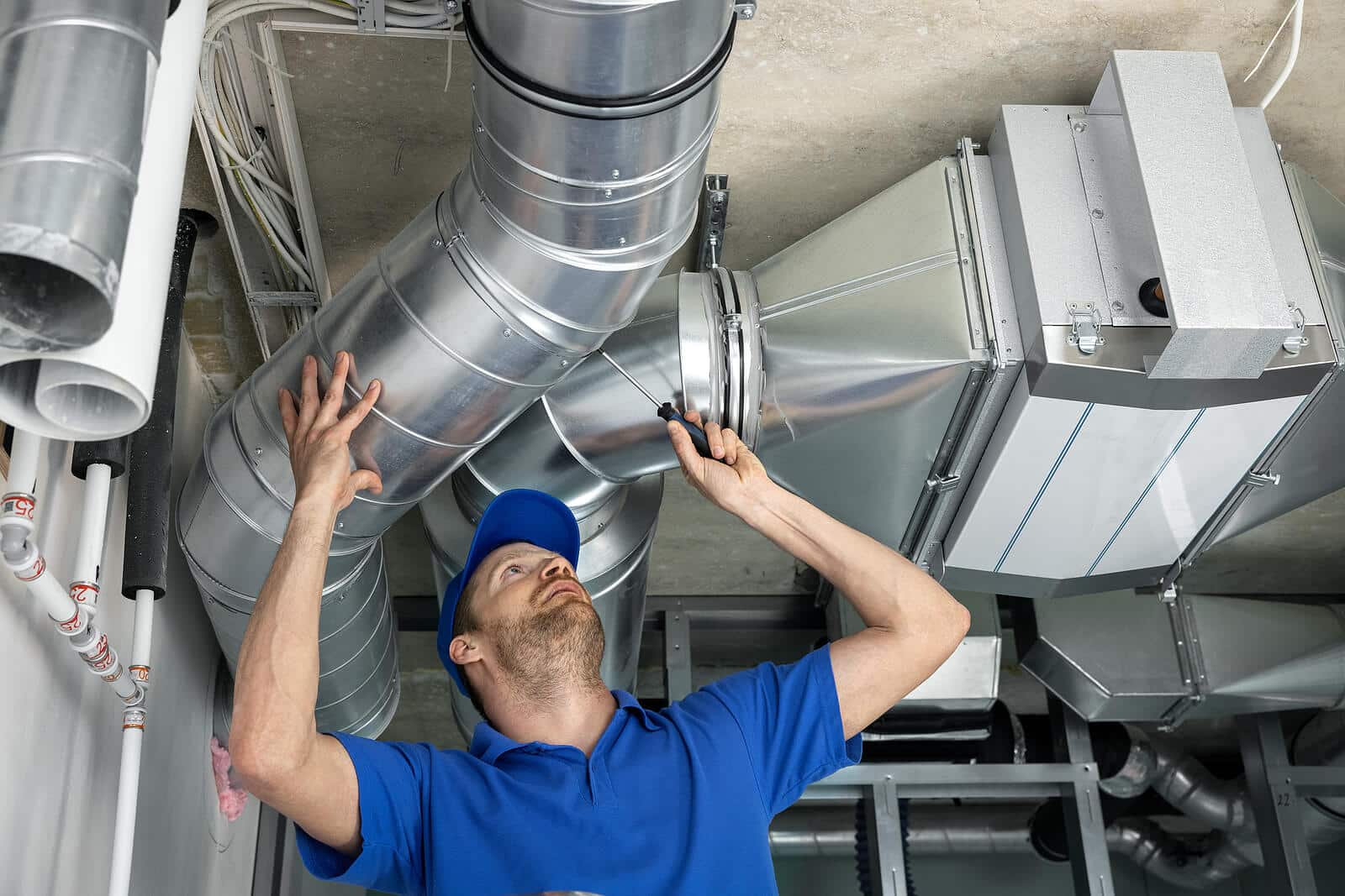 HVAC technician inspecting and repairing air ducts in Port Hueneme