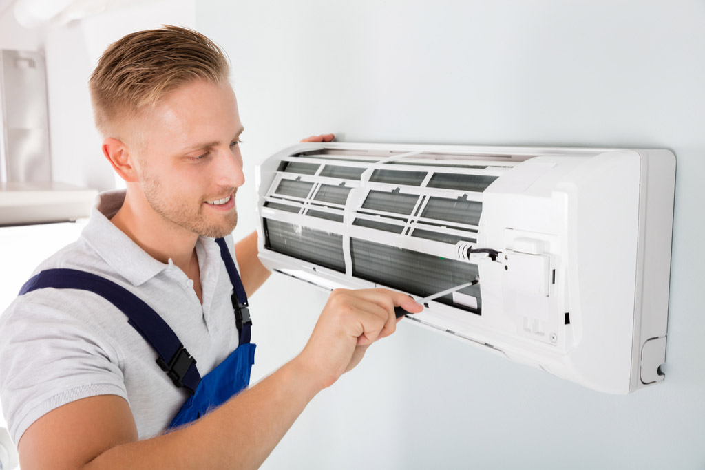 HVAC technician maintaining a ductless air conditioner in Port Hueneme
