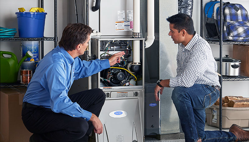 Technician evaluating a furnace for repair or replacement in Port Hueneme