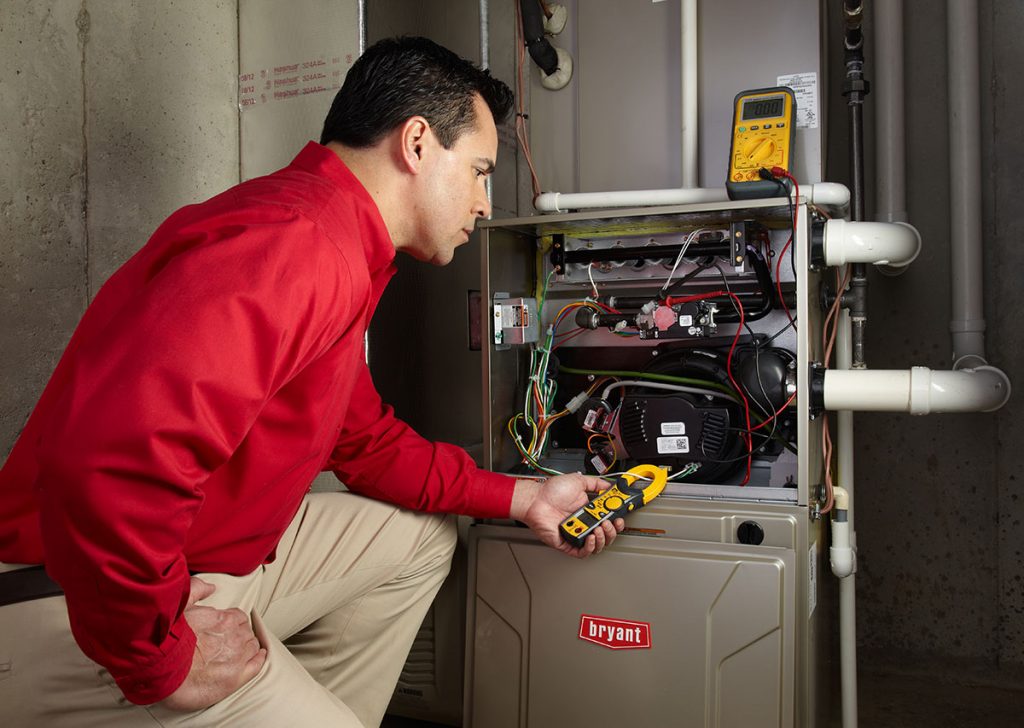 Heating technician diagnosing a furnace repair in Port Hueneme