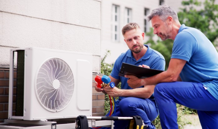 HVAC technicians installing an outdoor air conditioning unit in Port Hueneme
