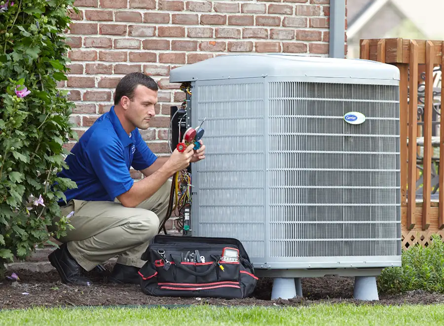 HVAC technician inspecting an outdoor AC unit in Port Hueneme